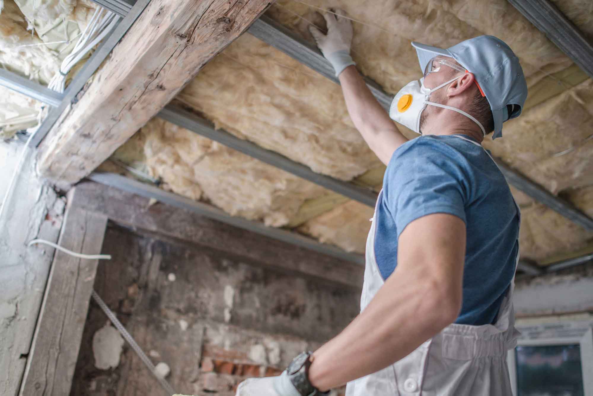 a worker checking the insulation of ceiling